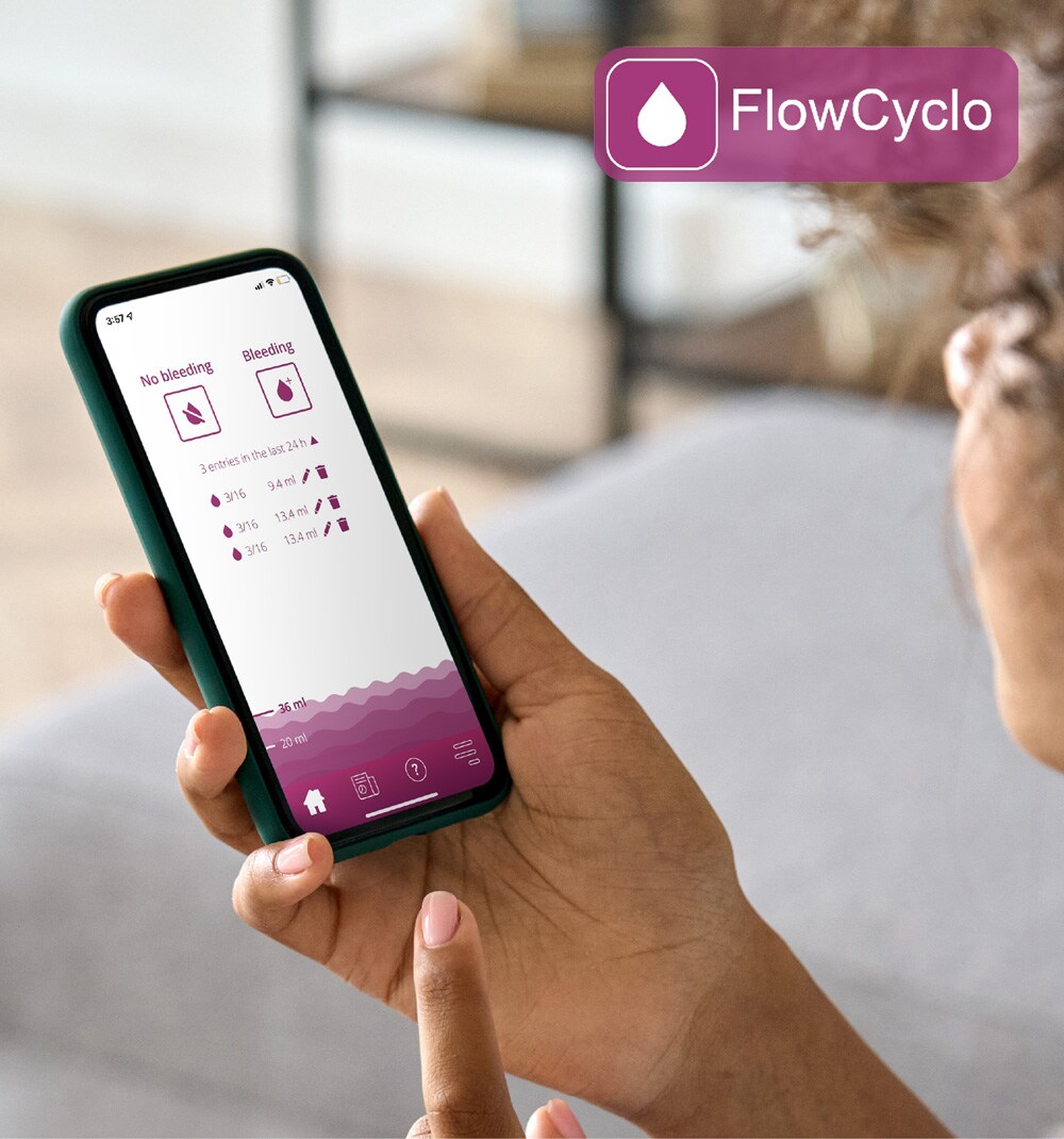 Young woman looking at the Flo  wCyclo app on her smartphone