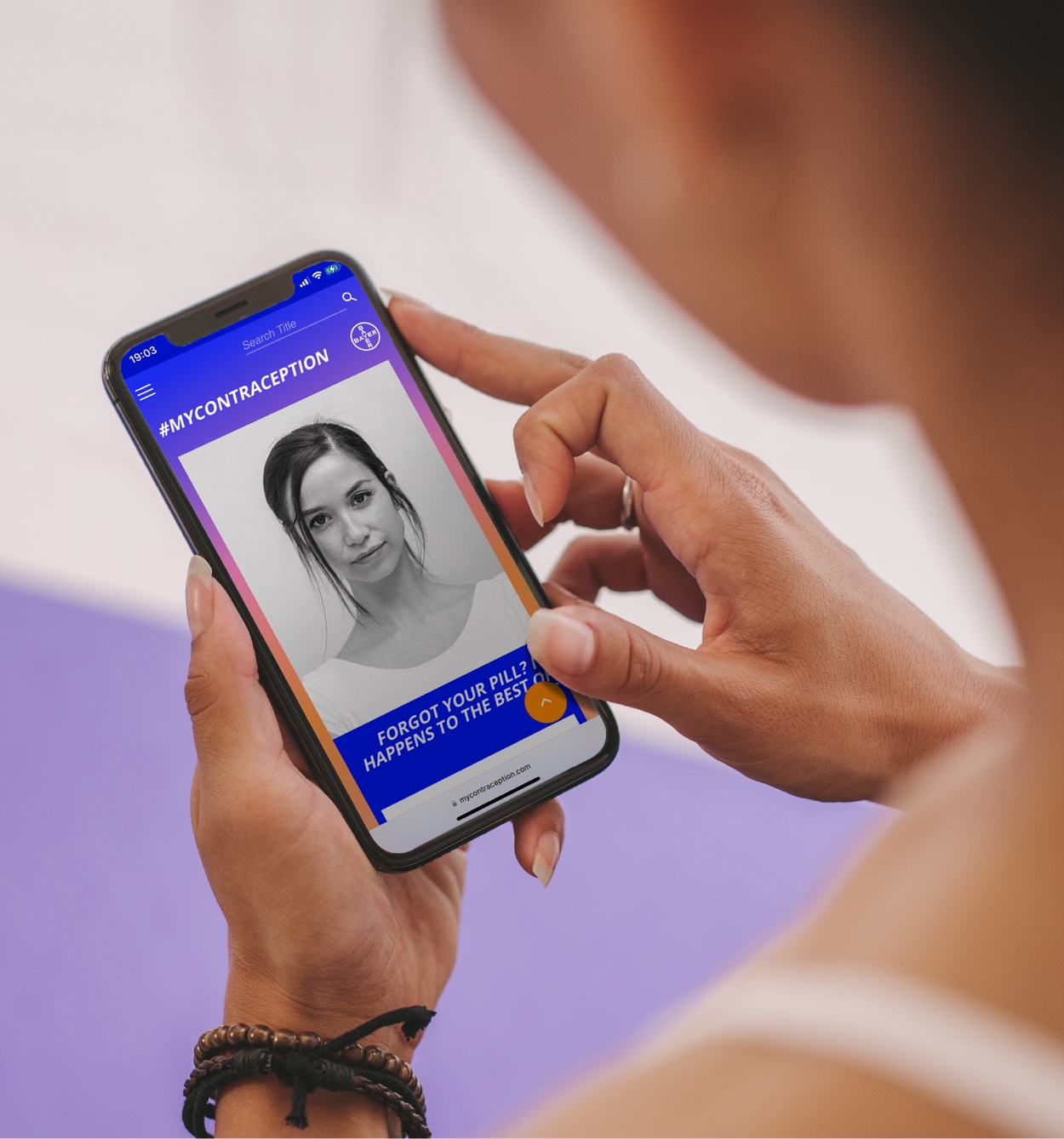 Young woman looking at the #MyContraception homepage on her smartphone