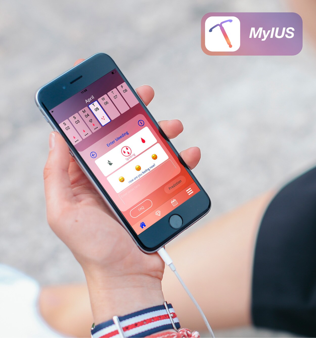 Young woman with headphones looking at the MyIUS app on her smartphone